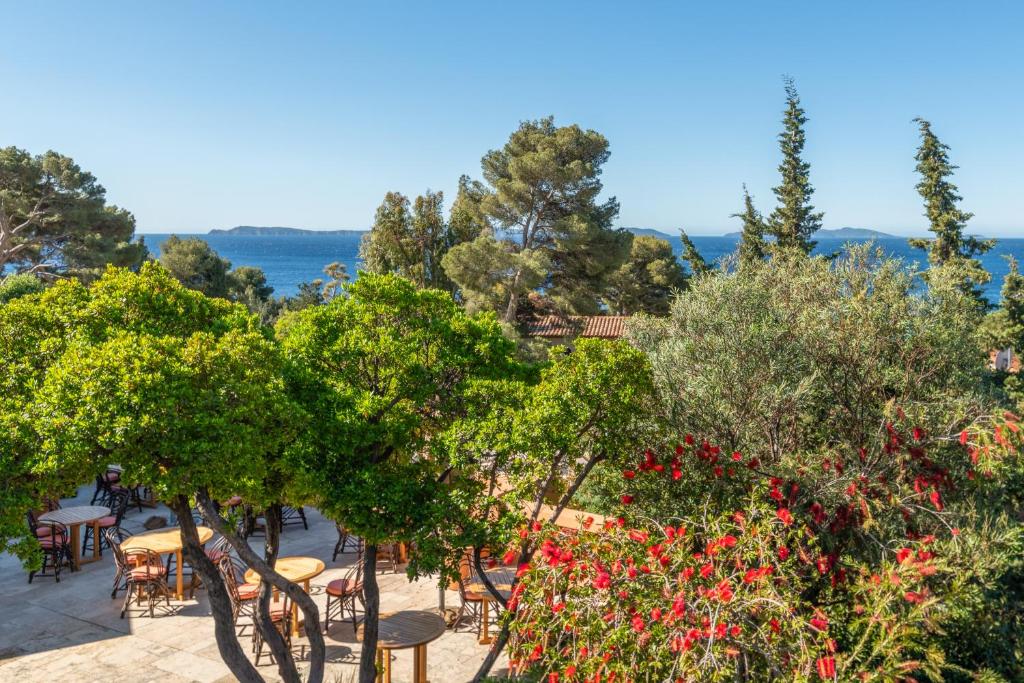 a view of a garden with trees and flowers at Les Terrasses du Bailli in Rayol-Canadel-sur-Mer