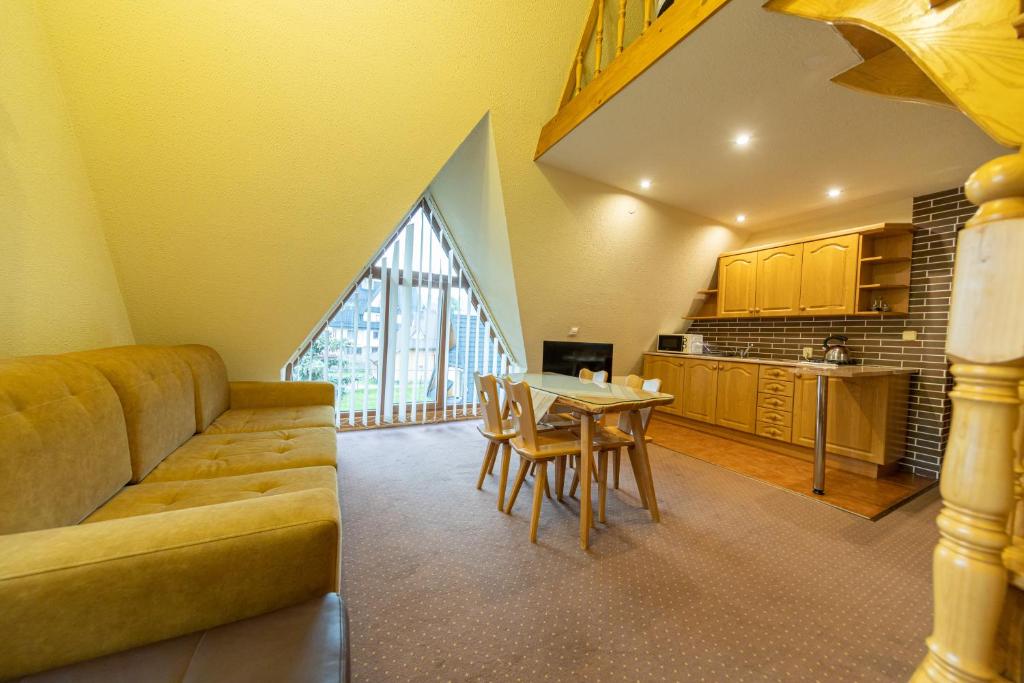 a living room with a couch and a table at Willa Krokus in Zakopane