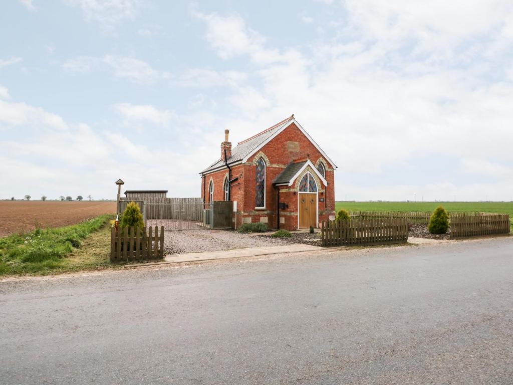 an old brick church on the side of the road at Richrose Chapel in Spalding