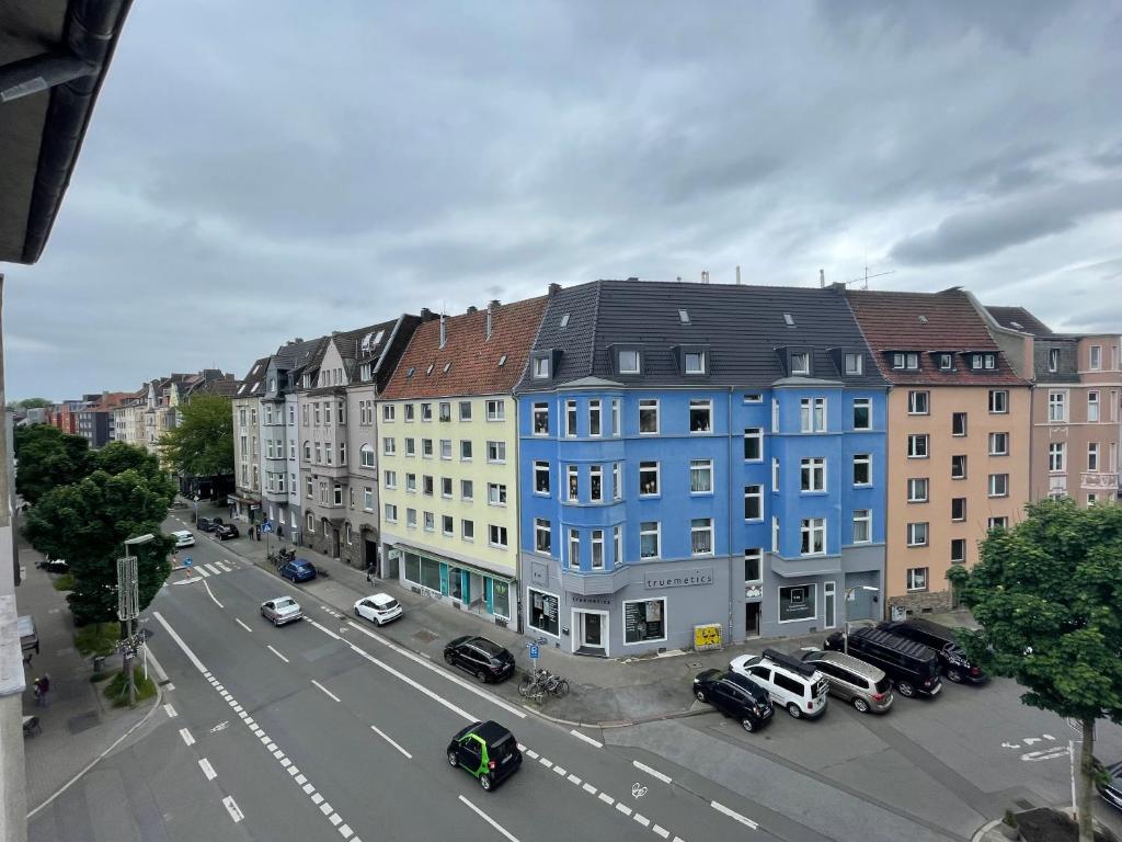 a large blue building on a city street with cars at Nähe BVB Stadion Dortmund City Innenstadt in Dortmund