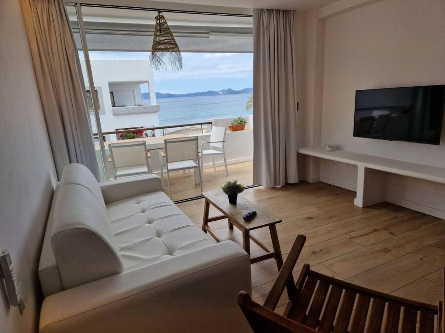 a living room with a white couch and a view of the ocean at El balcon de formentera in La Savina