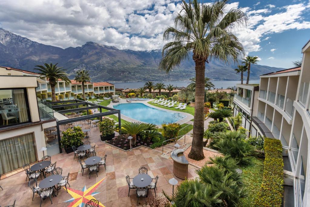 an aerial view of a resort with a pool and palm tree at Park Hotel Imperial in Limone sul Garda