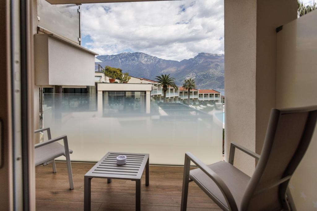 a room with a large window with a view of the mountains at Park Hotel Imperial in Limone sul Garda