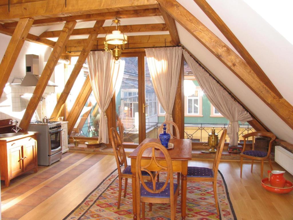 a kitchen with a table and chairs in a room at Casa Rozelor in Braşov