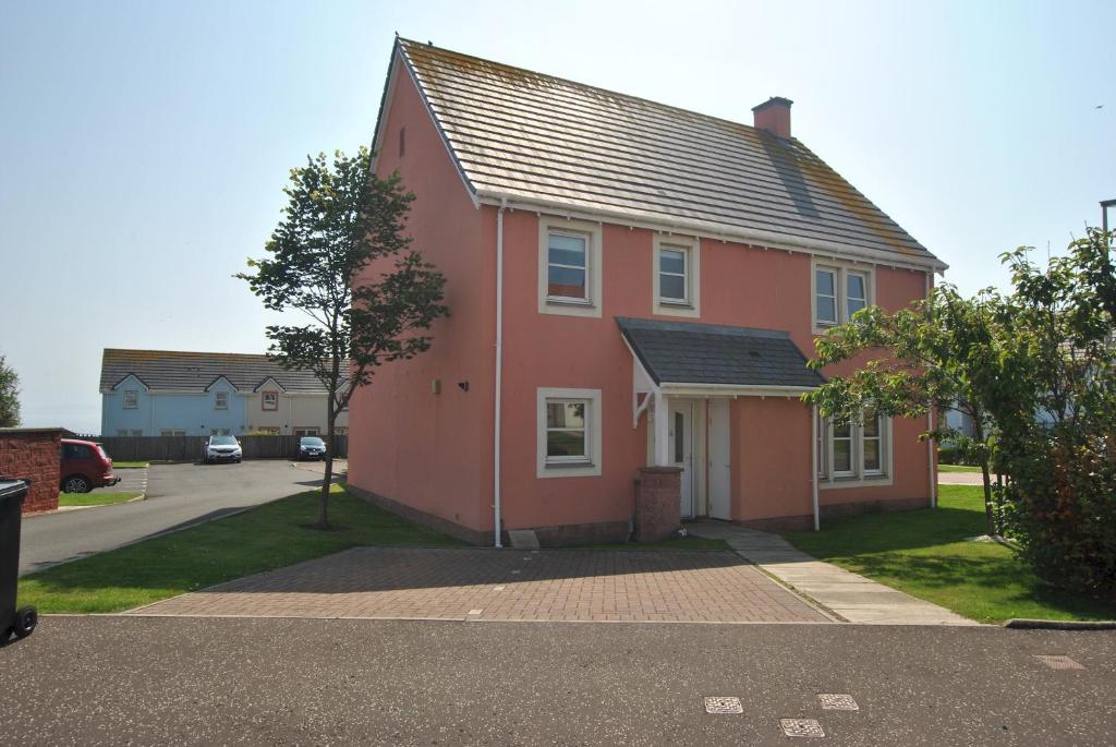 a red house on the side of a street at Seahaven- family home in East Neuk coastal village in Anstruther