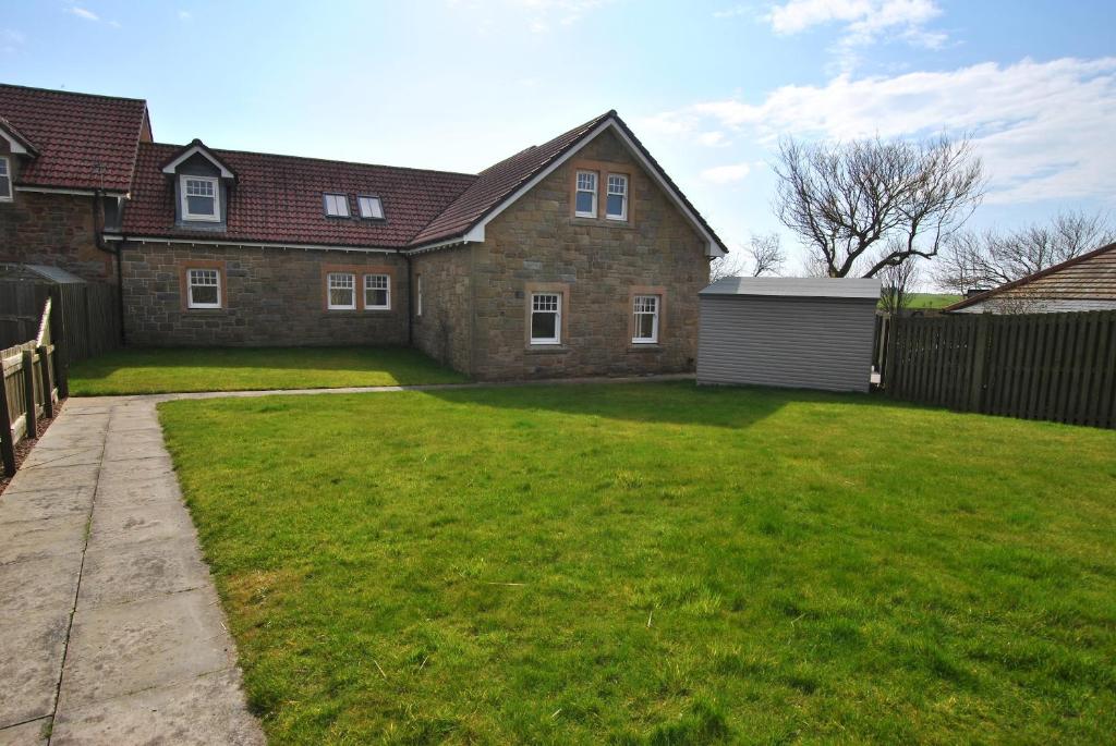 a house with a yard with a fence at Darnley View- spacious countryside retreat in Crail