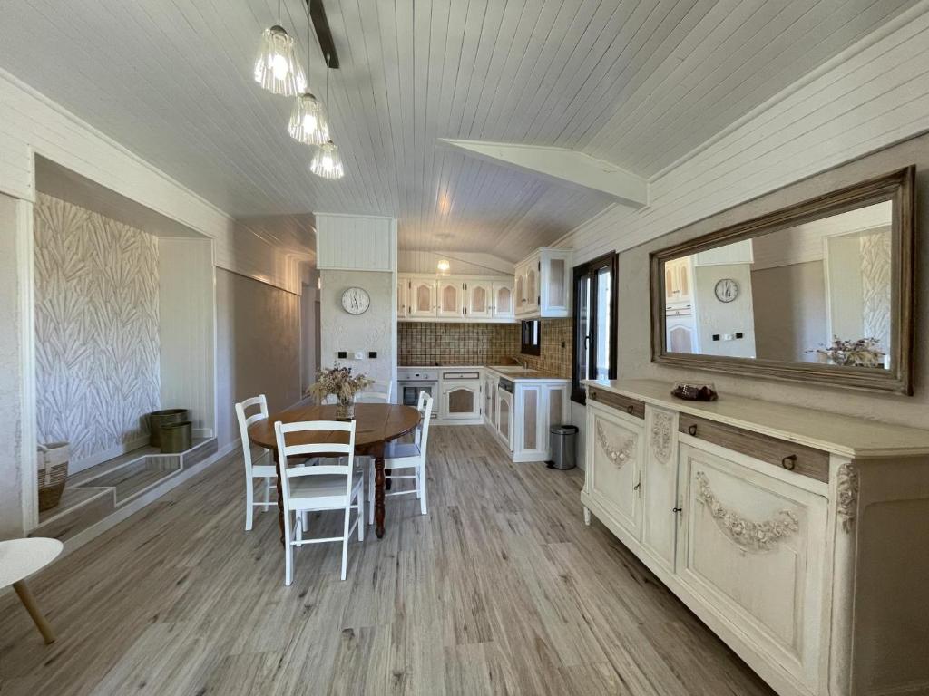 a kitchen and dining room with a table and chairs at Cyralie in Asson