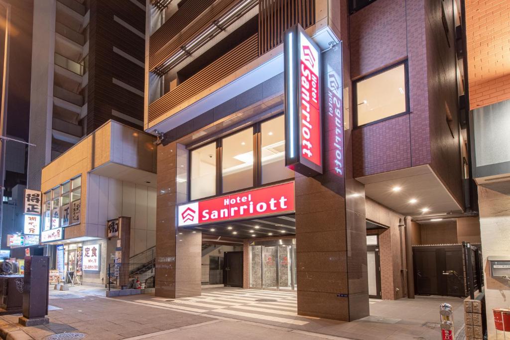 un bâtiment avec un panneau indiquant un supermarché chaud dans l'établissement Hotel Sanrriott Osaka Hommachi, à Osaka