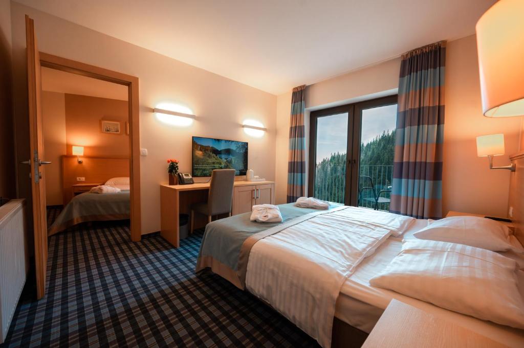 Postelja oz. postelje v sobi nastanitve Wellness Hotel Montis