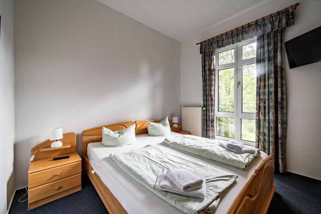 Postel nebo postele na pokoji v ubytování Appartement-Hotel-Anlage Tannenpark