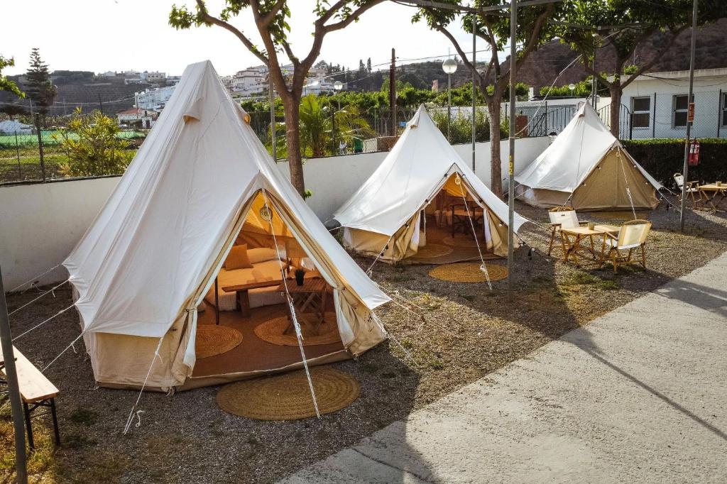 a group of tents sitting next to a fence at Kampaoh Costa del Sol in Caserío Almayate Bajo