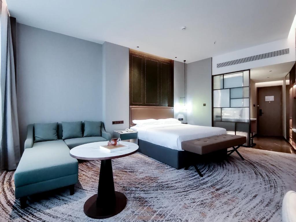 Postel nebo postele na pokoji v ubytování Shenzhen Shanghai Hotel