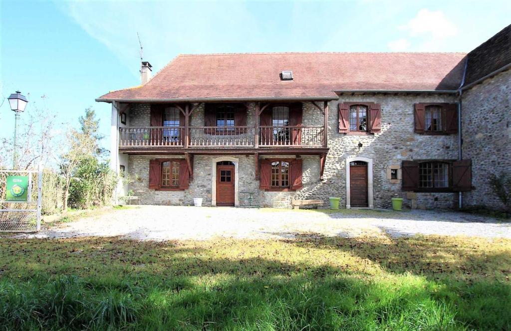 a large stone house with a balcony on top of it at Aguerre in Lichos