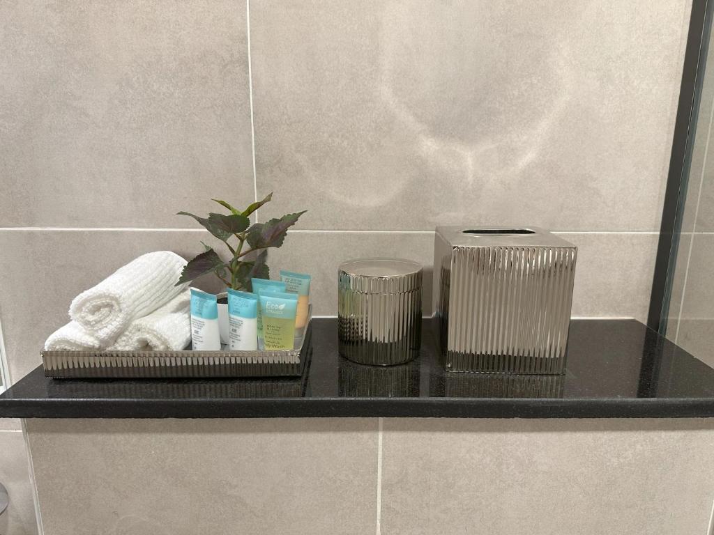 a shelf in a bathroom with toiletries on it at Tranquil Studio in Damac Hills in Dubai