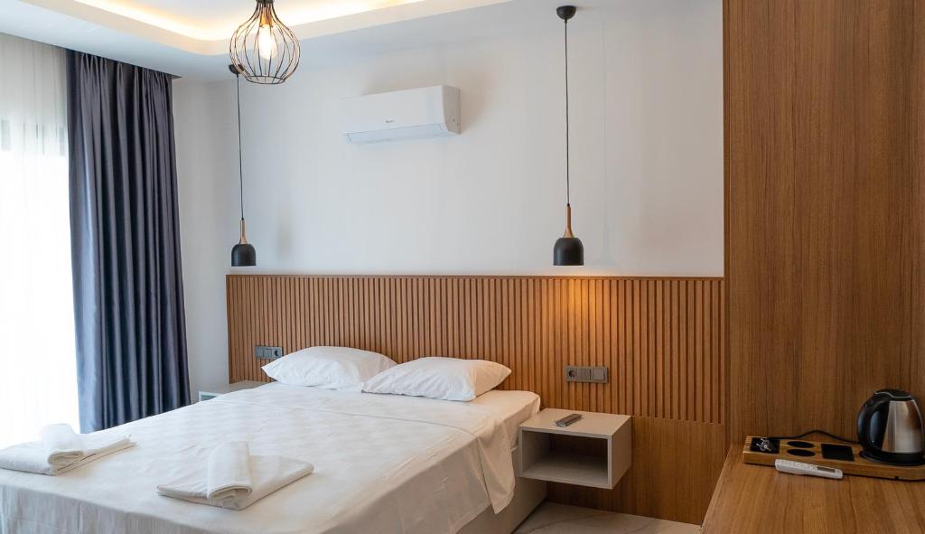 a bedroom with a bed with two towels on it at Vira Apart Suites in Göcek