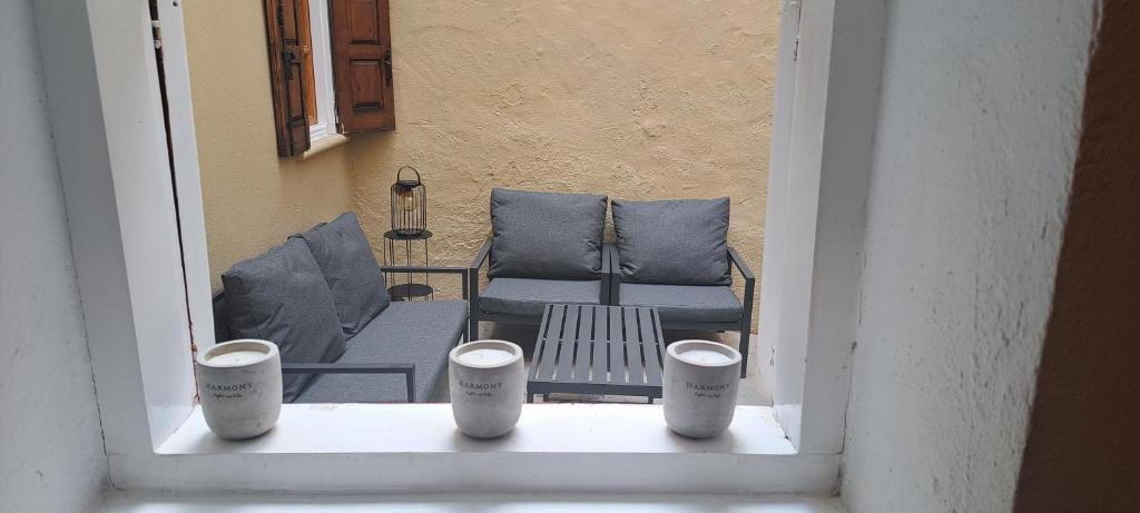 a view of a patio with chairs and a table at The Retreat in the heart of Old Town Rhodes in Rhodes Town