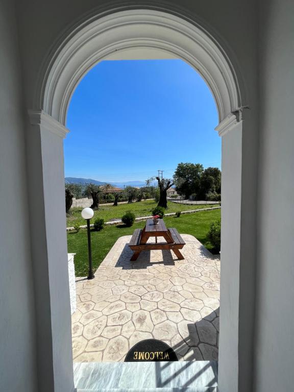 an archway with a picnic table in a park at Ilias Apartments Dassia By Hotelius in Dassia