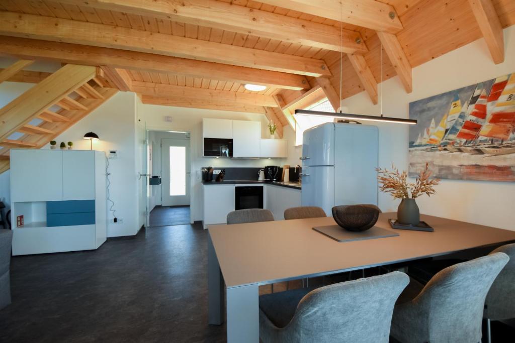 a kitchen and dining room with a table and chairs at MP23 - Strandvogt 3 Komfort in Dorum Neufeld