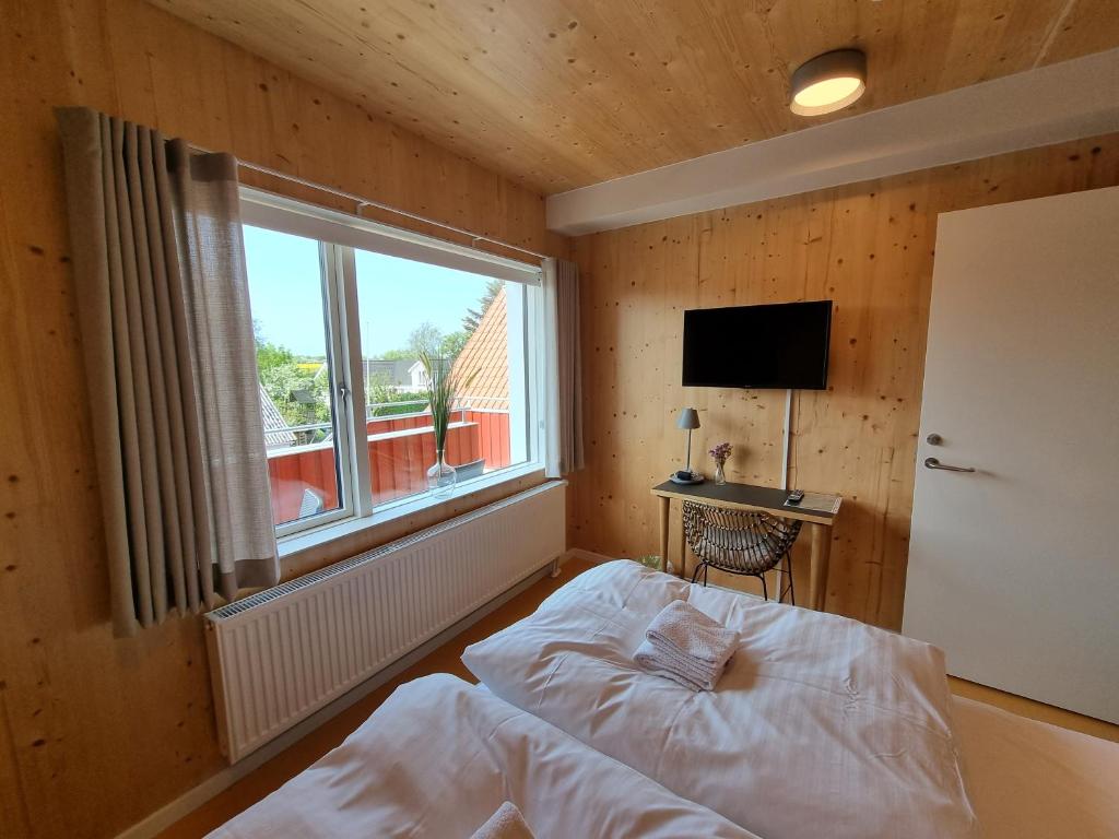Postel nebo postele na pokoji v ubytování Skovsgård Hotel