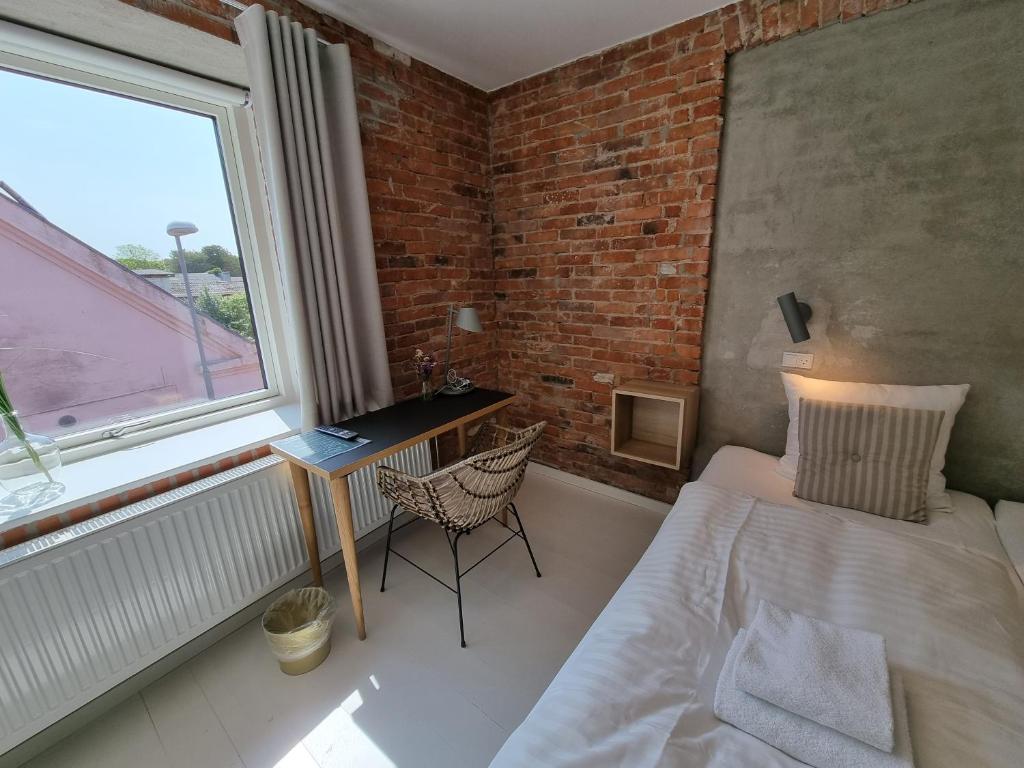 Postel nebo postele na pokoji v ubytování Skovsgård Hotel