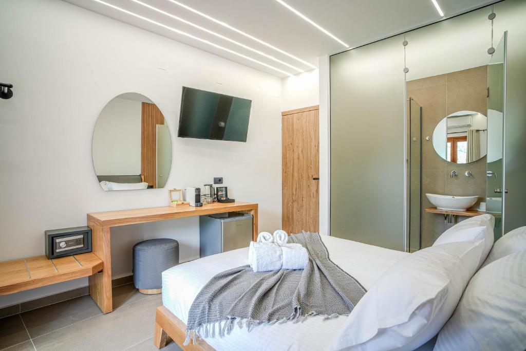 Postel nebo postele na pokoji v ubytování Omnia Deluxe Rooms