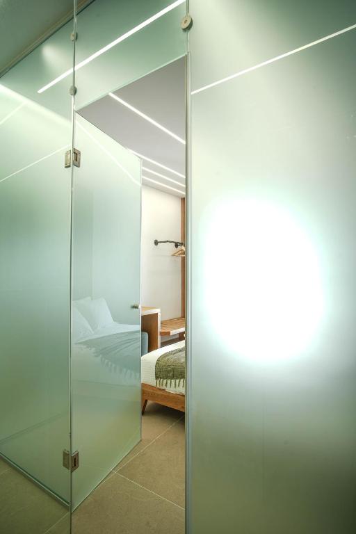 Postel nebo postele na pokoji v ubytování Omnia Deluxe Rooms