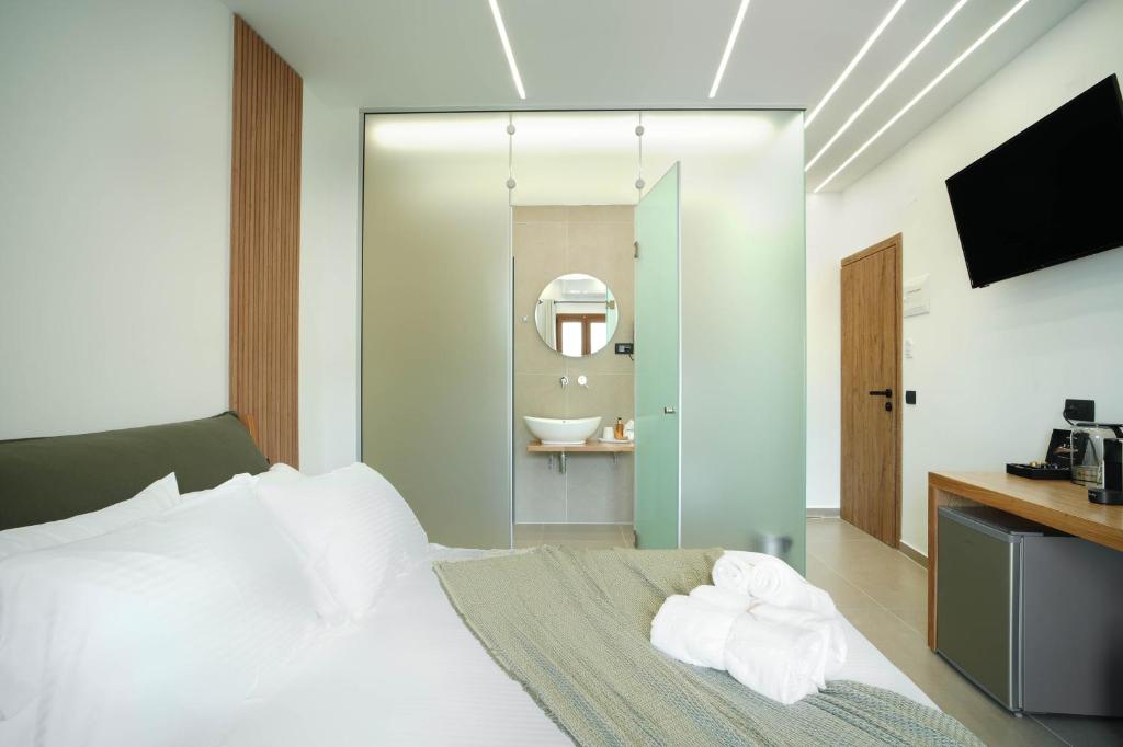 Postel nebo postele na pokoji v ubytování Omnia Deluxe Rooms