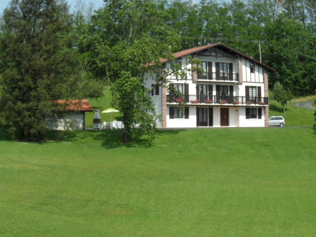 a large white house in a field of green grass at Iparla in Urrugne
