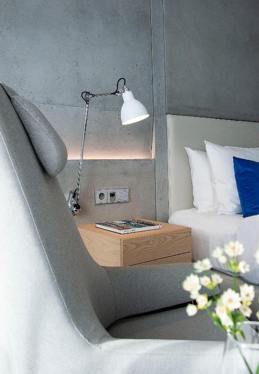 a bedroom with a bed and a desk with a lamp at Renaissance Warsaw Airport Hotel in Warsaw