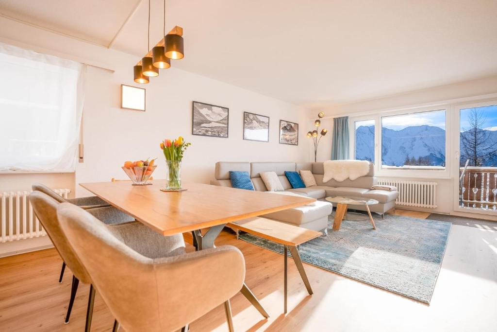 a living room with a table and a couch at Valaisia 145 in Riederalp