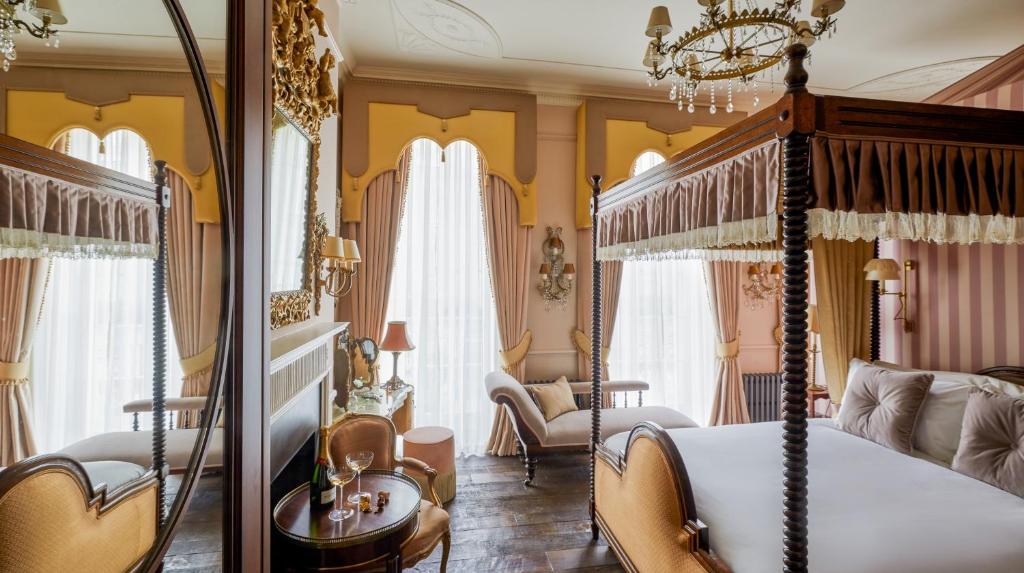a bedroom with a canopy bed and a living room at Henrys Townhouse Marylebone, London in London