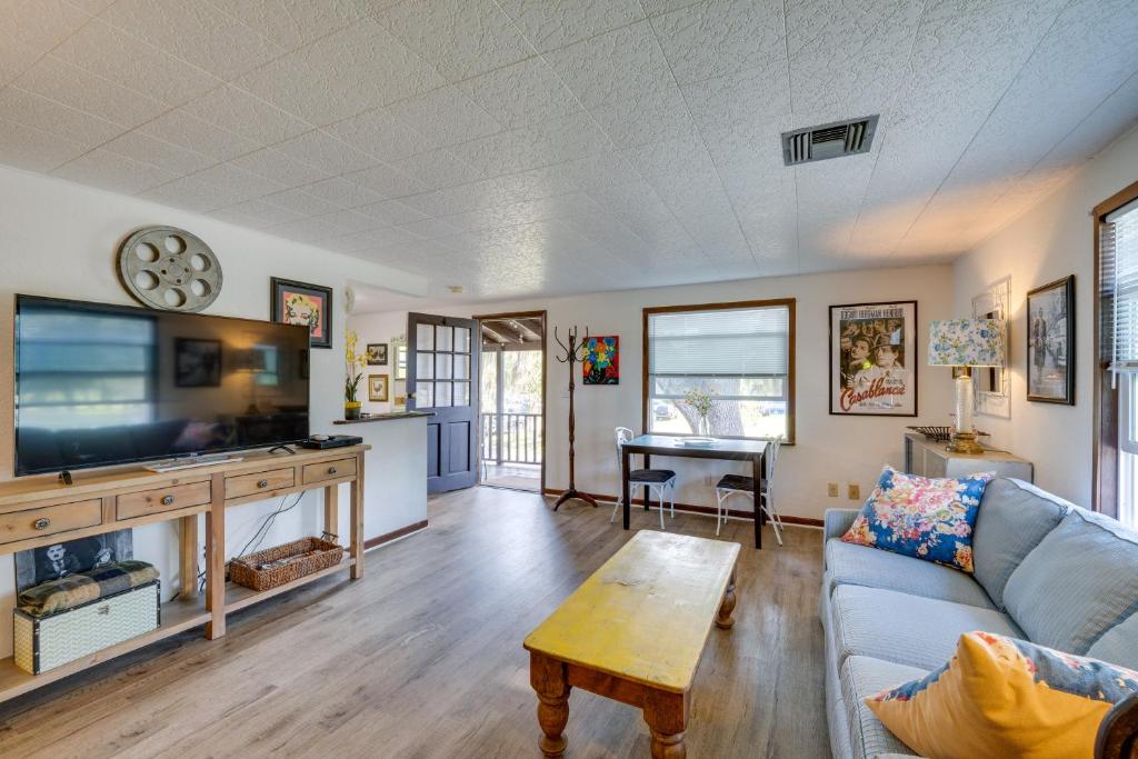 a living room with a couch and a tv at Pet-Friendly Mt Dora Apartment with Deck - Near Lake in Mount Dora