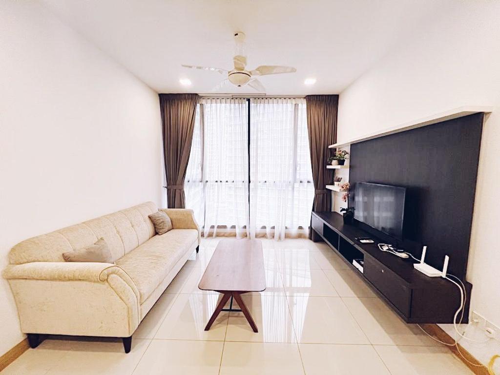 a living room with a couch and a flat screen tv at PROMO Connected Train 2 Bedroom ABOVE MALL 9 in Kuala Lumpur