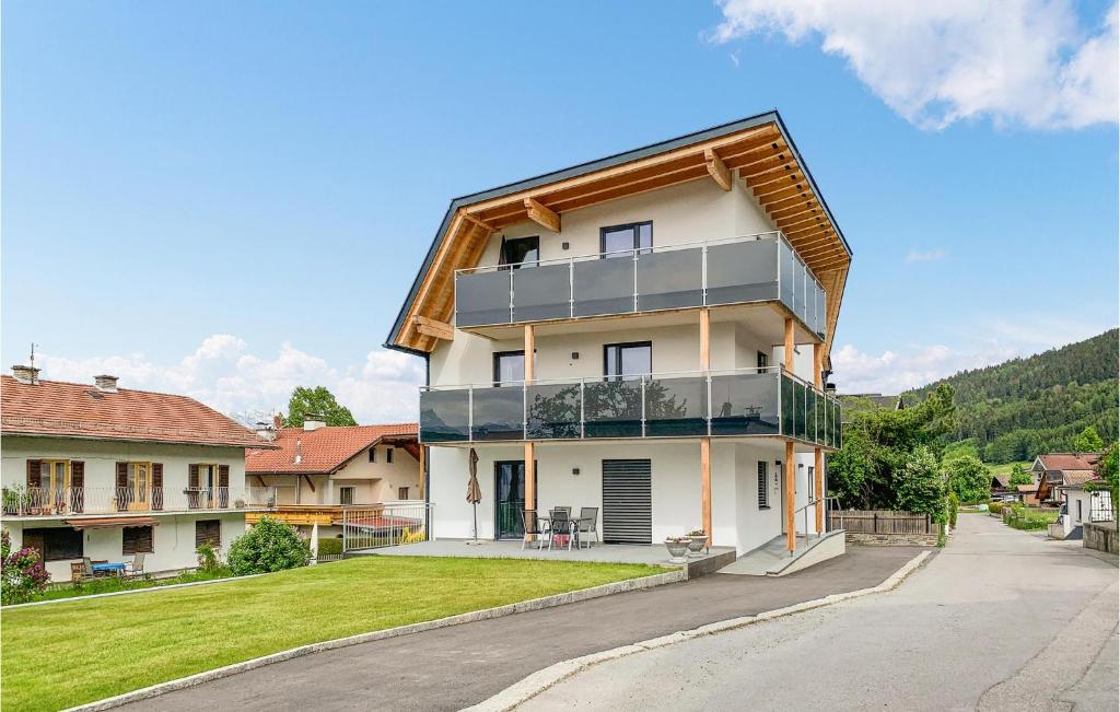 a large white house with a gambrel roof at Cozy Apartment In Axams With Kitchen in Innsbruck