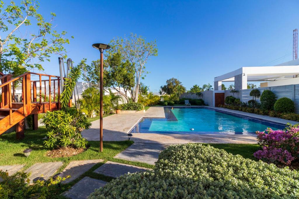 a swimming pool in the yard of a house at Modern 4-BR Villa with Pool in Punta Cana Residential Area in Punta Cana