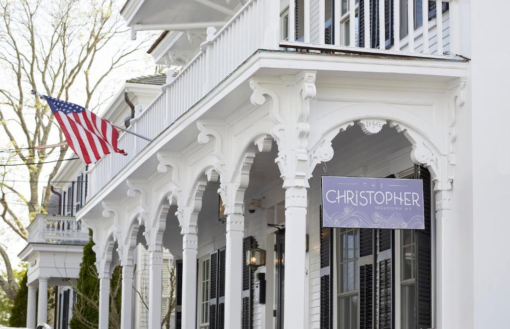 a white building with an american flag in front of it at The Christopher, The Edgartown Collection in Edgartown