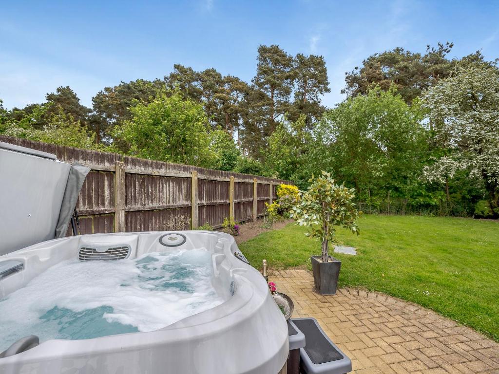 a hot tub in the backyard of a yard at Pittendrigh Cottage in Briston