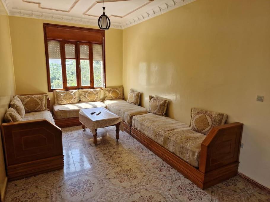 a living room with a couch and a table at Large Family Apartment by Beach & center of town in Asilah