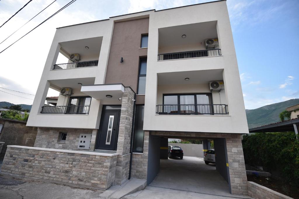 a building with two balconies and a driveway at VILA PERLA in Trebinje