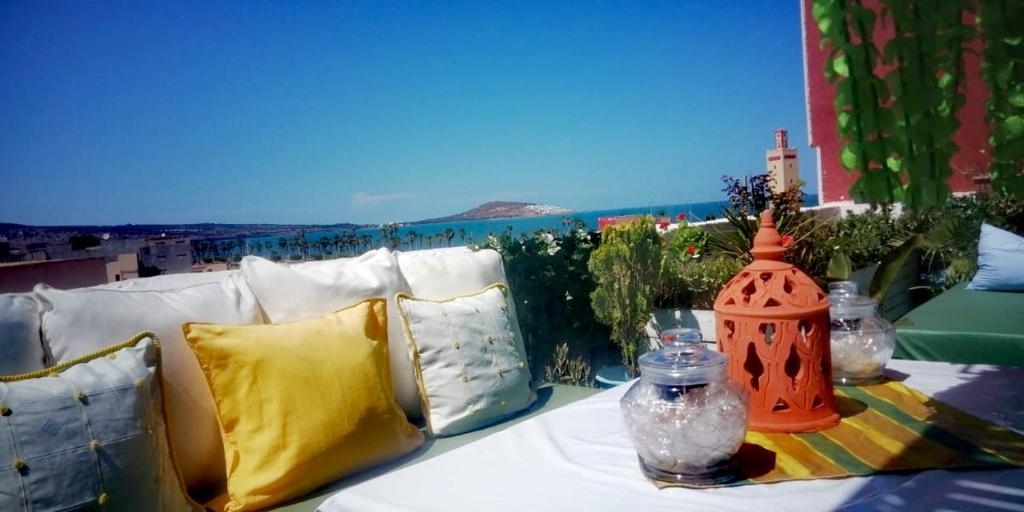 a white couch with pillows and a table with a view at SARA HOUSE NADOR in Nador