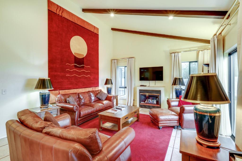 a living room with leather furniture and a fireplace at Spacious Flagstaff Vacation Rental - 1 Mi to Dtwn in Flagstaff