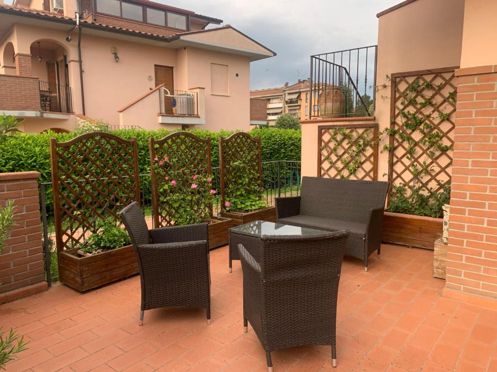 patio z krzesłami, stołem i ogrodzeniem w obiekcie Appartamento Valdichiana w mieście Bettolle