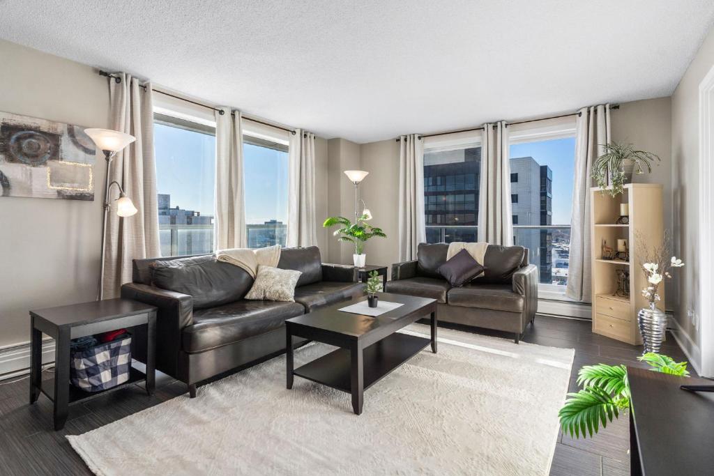 a living room with a couch and a table at Superb 2 bedroom downtown with river view in Saskatoon