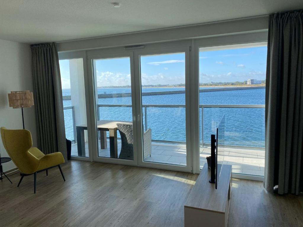 a living room with a view of the ocean at Residenz Bollwark 312 in Kappeln
