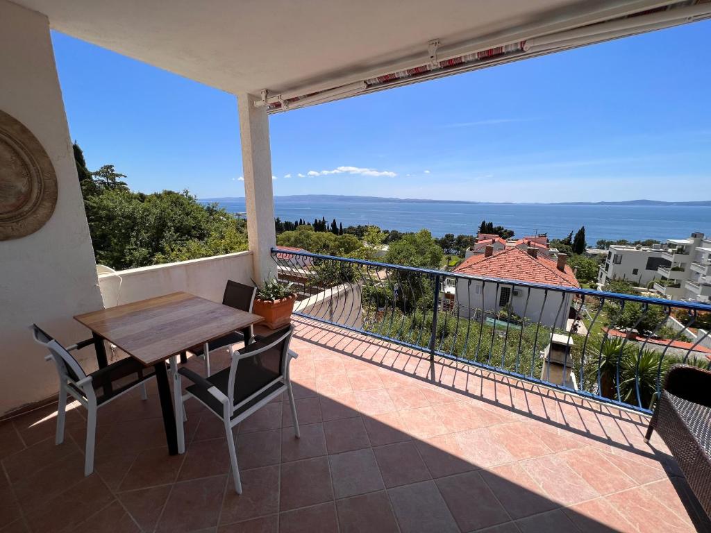 a patio with a wooden table and chairs on a balcony at Adriatic View in Split