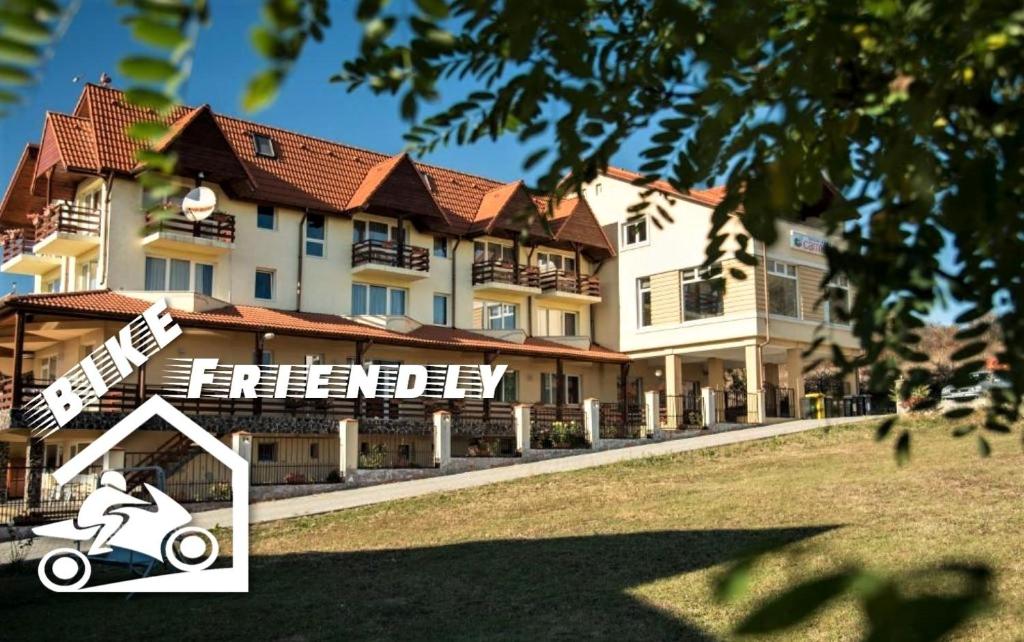 a rendering of a hotel with a scooter in front of it at Pensiunea Carmen in Sibiu