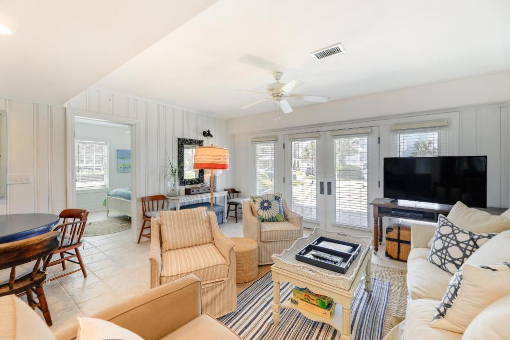 a living room filled with furniture and a flat screen tv at Atlantic Beach Condo - Walk to Beaches! in Atlantic Beach