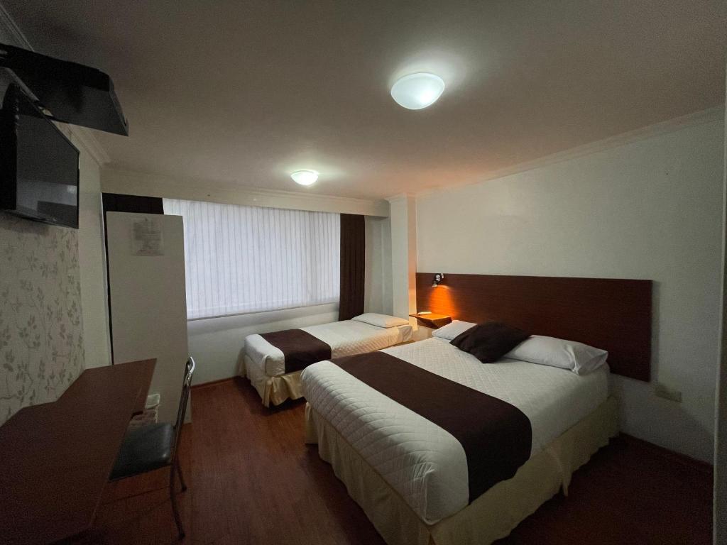 Postel nebo postele na pokoji v ubytování Gran Hotel Napoleón