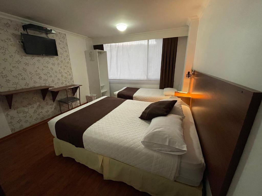 Postel nebo postele na pokoji v ubytování Gran Hotel Napoleón