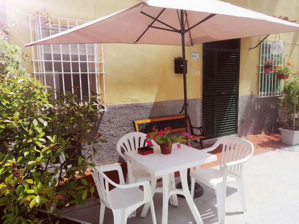a white table and chairs with an umbrella at Pierina in Lucca